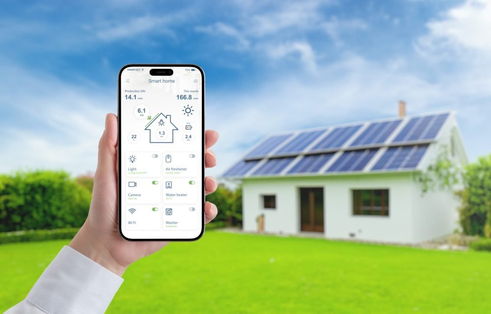 Hand holding smartphone with smart home app, monitoring solar panel energy, temperature, and home consumption, advancing the concept of efficient green living