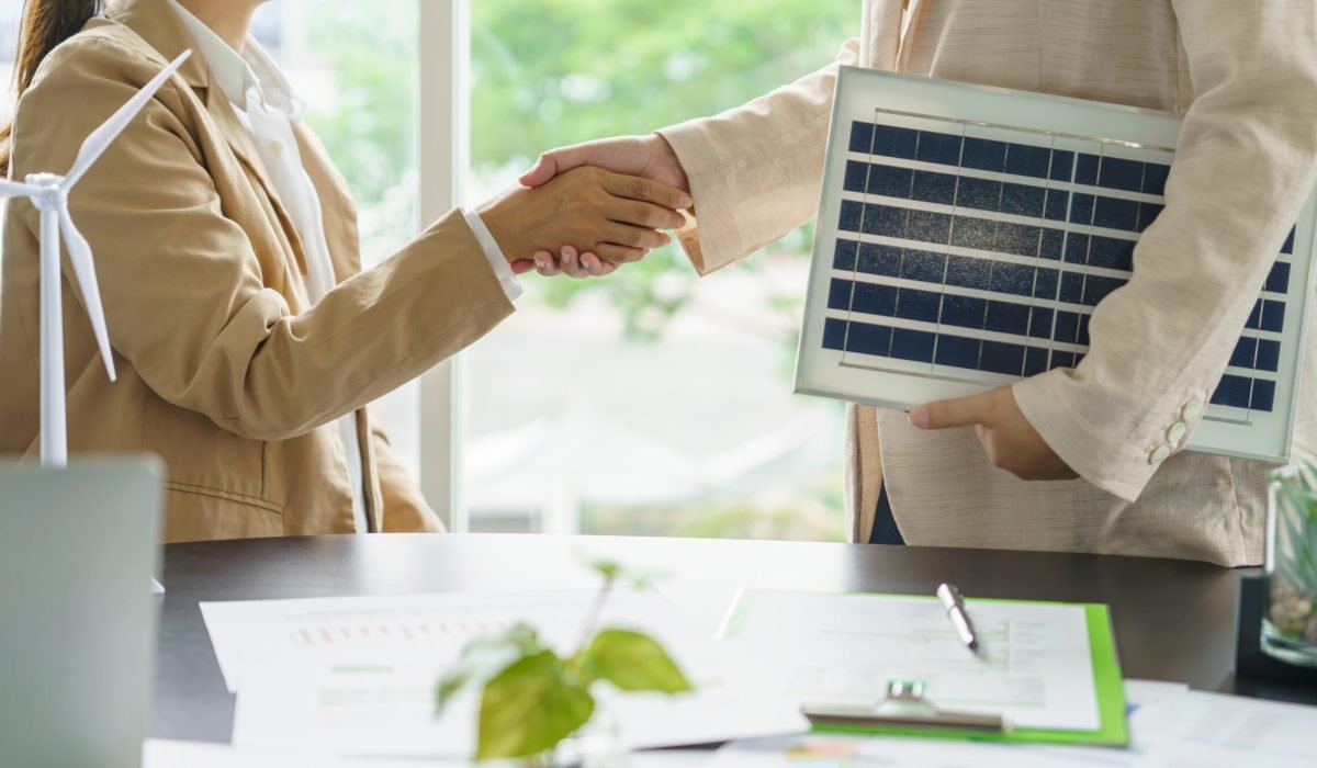 Handshake and business with solar panels green energy Business p Handshake and business with solar panels green energy Business people working in green eco friendly office business meeting creative ideas for business eco friendly.